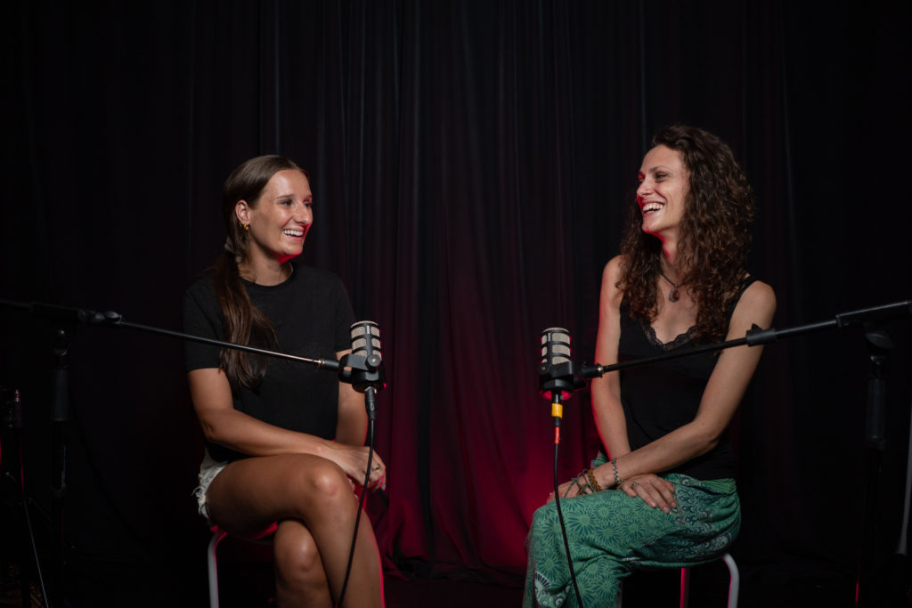 Two pretty women talking in podcast studio